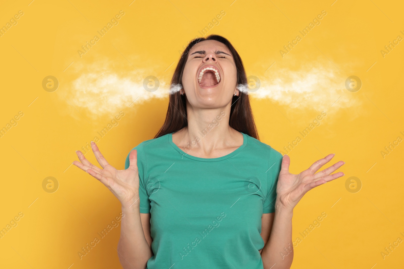 Image of Aggressive woman with steam coming out of her ears on orange background