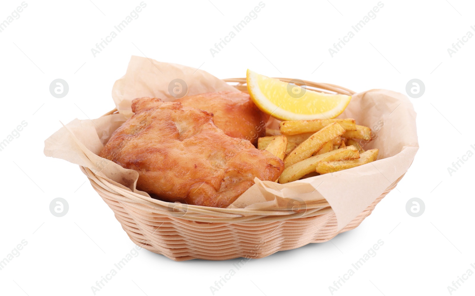 Photo of Tasty fish, chips and lemon in wicker bowl isolated on white