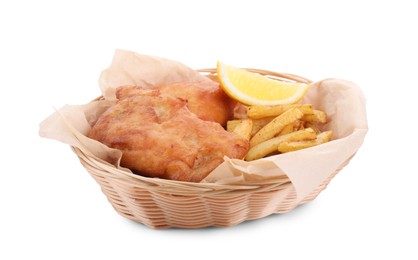 Photo of Tasty fish, chips and lemon in wicker bowl isolated on white