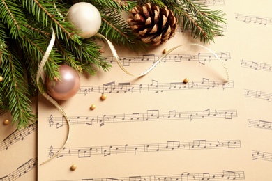 Flat lay composition with Christmas decorations on music sheets