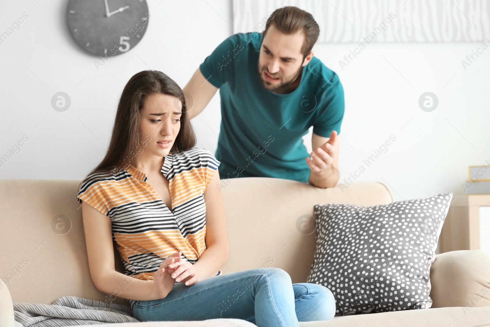 Photo of Young couple having argument in living room