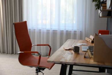 Photo of Modern workplace with comfortable chair in stylish home office interior