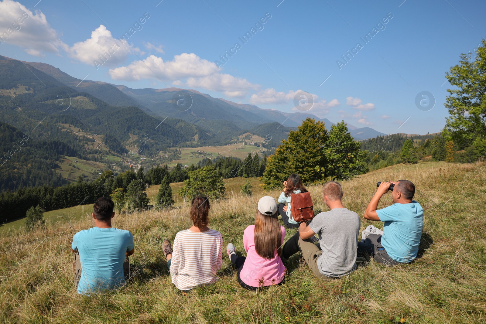 Photo of Group of people spending time together in mountains, back view