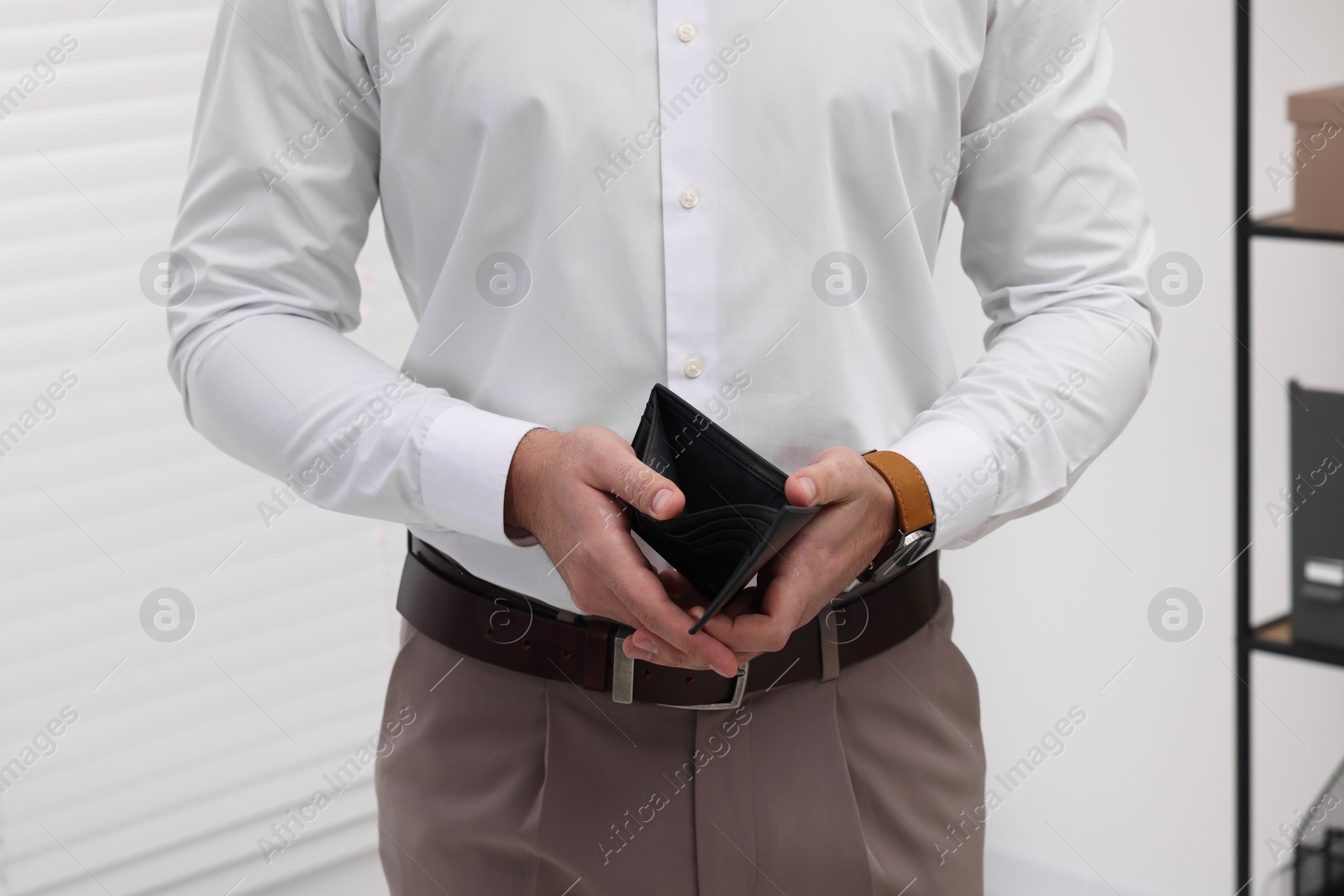 Photo of Man with empty wallet in office, closeup