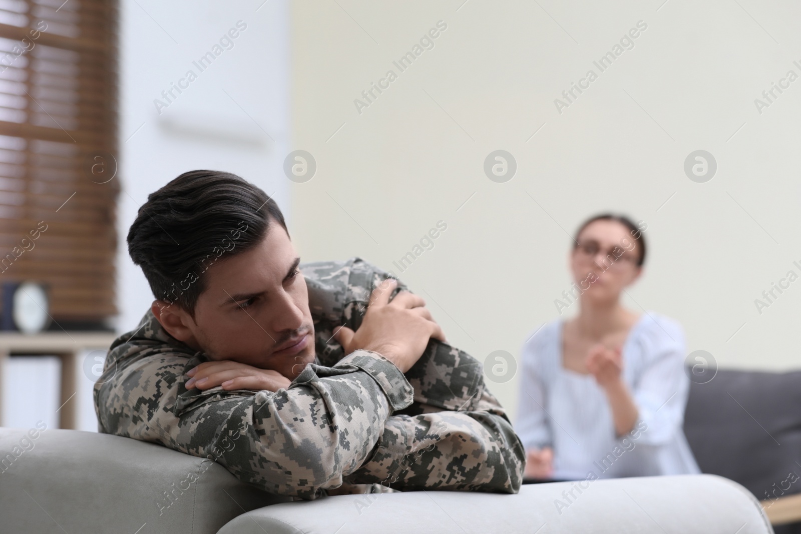 Photo of Male military officer having appointment with psychotherapist in office