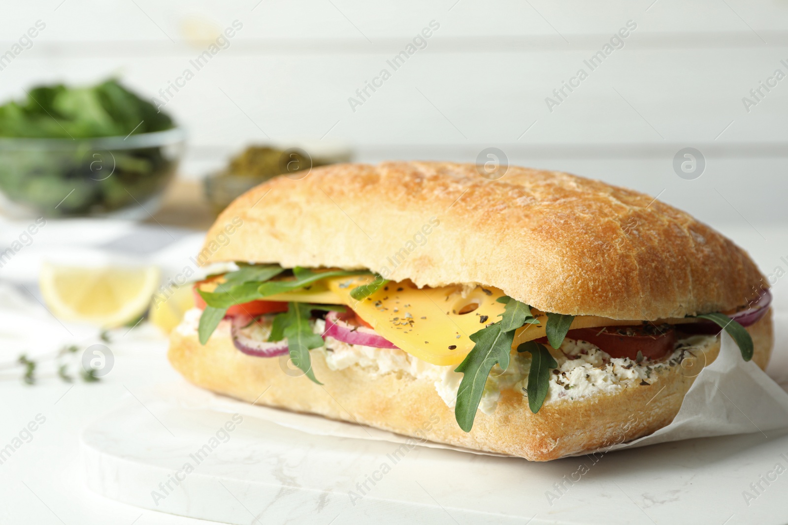 Photo of Delicious sandwich with fresh vegetables and cheese on white table