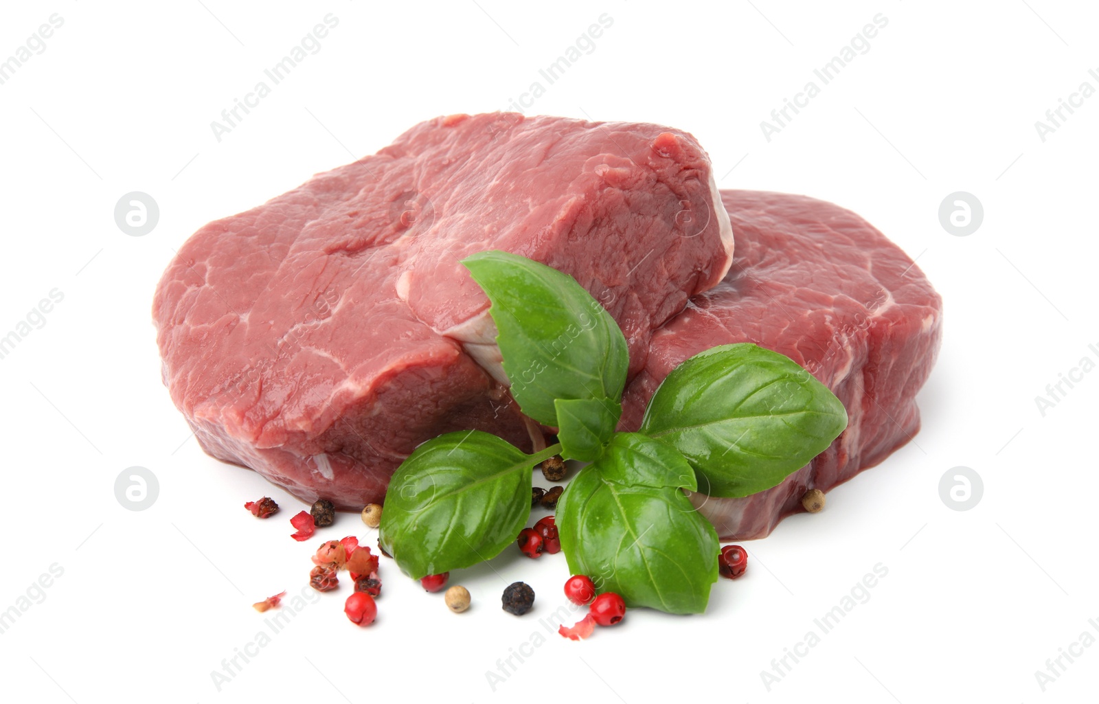 Photo of Fresh beef meat with basil leaves and spices isolated on white