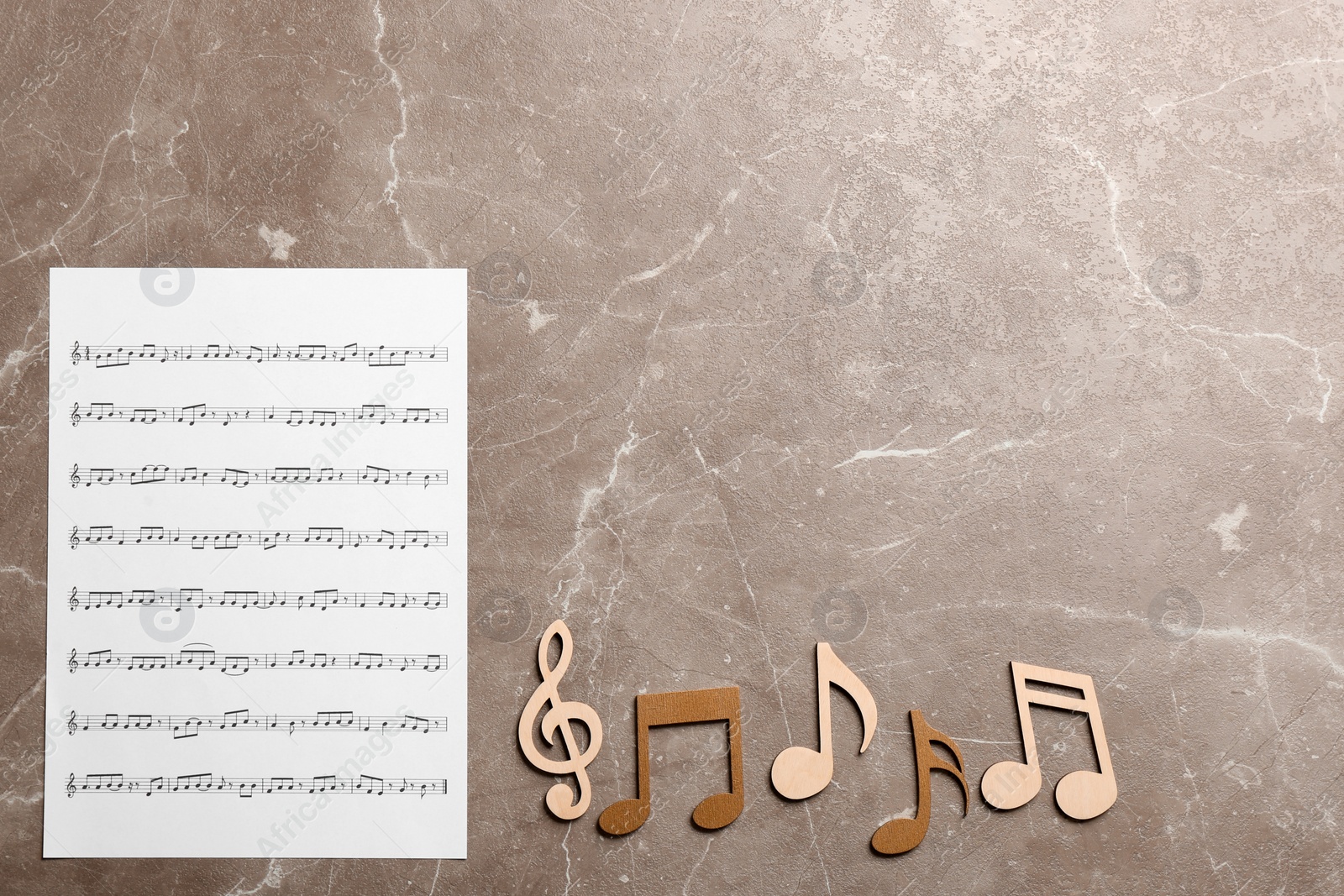 Photo of Sheet and music notes on color background, top view. Space for text