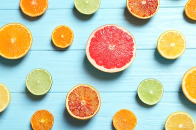 Flat lay composition with different citrus fruits on wooden background