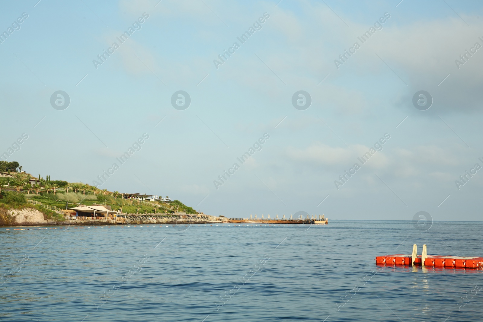 Photo of Picturesque view of sea and shore under blue sky