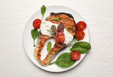 Photo of Tasty salmon steak served on white wooden table, top view