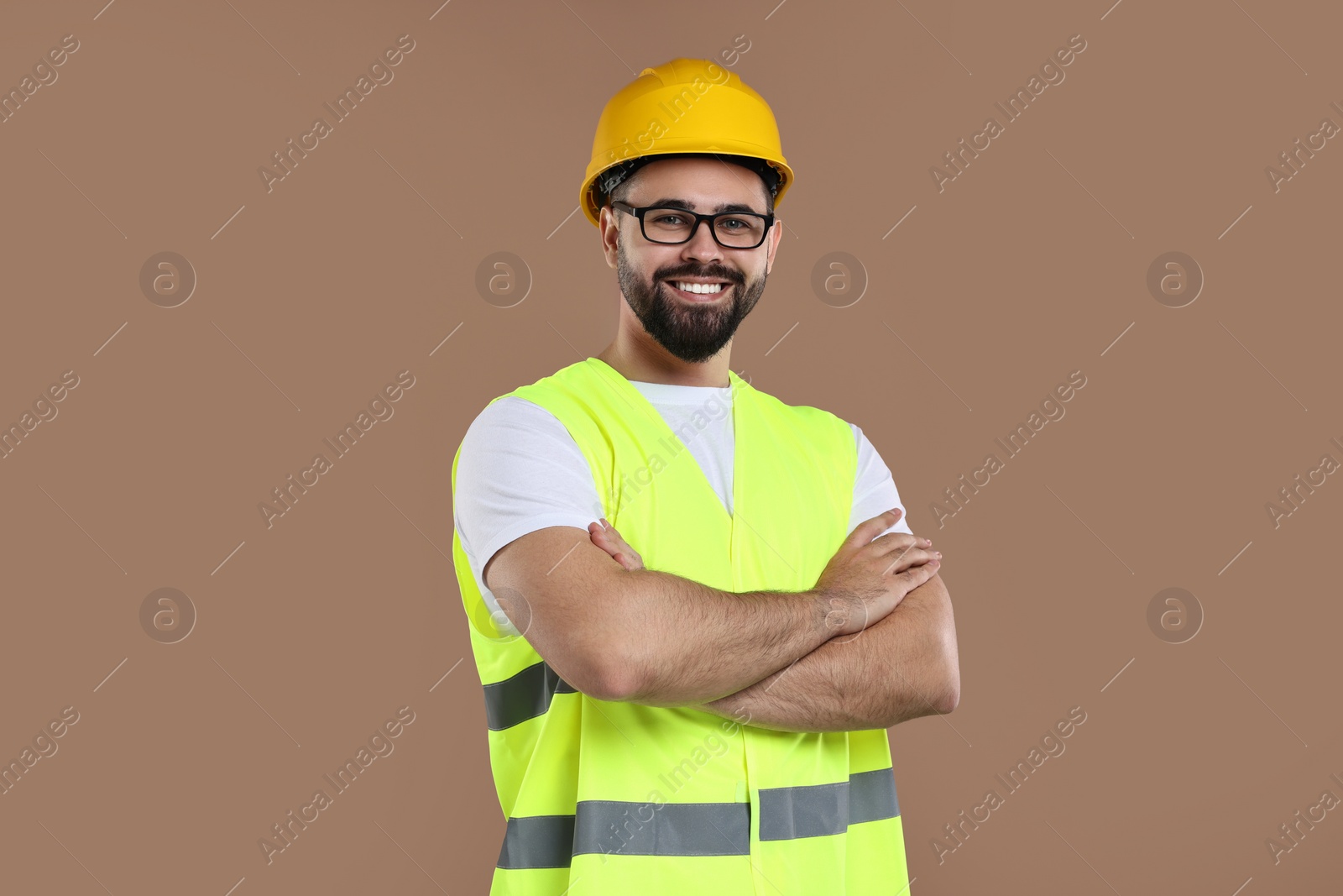 Photo of Engineer in hard hat on brown background