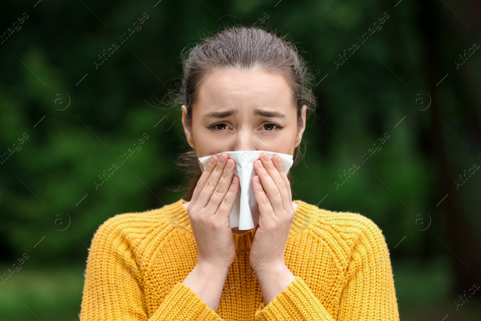 Photo of Woman suffering from seasonal spring allergy outdoors