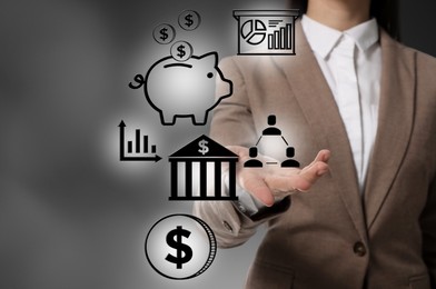Budget management. Businesswoman demonstrating virtual financial icons on gray background, closeup