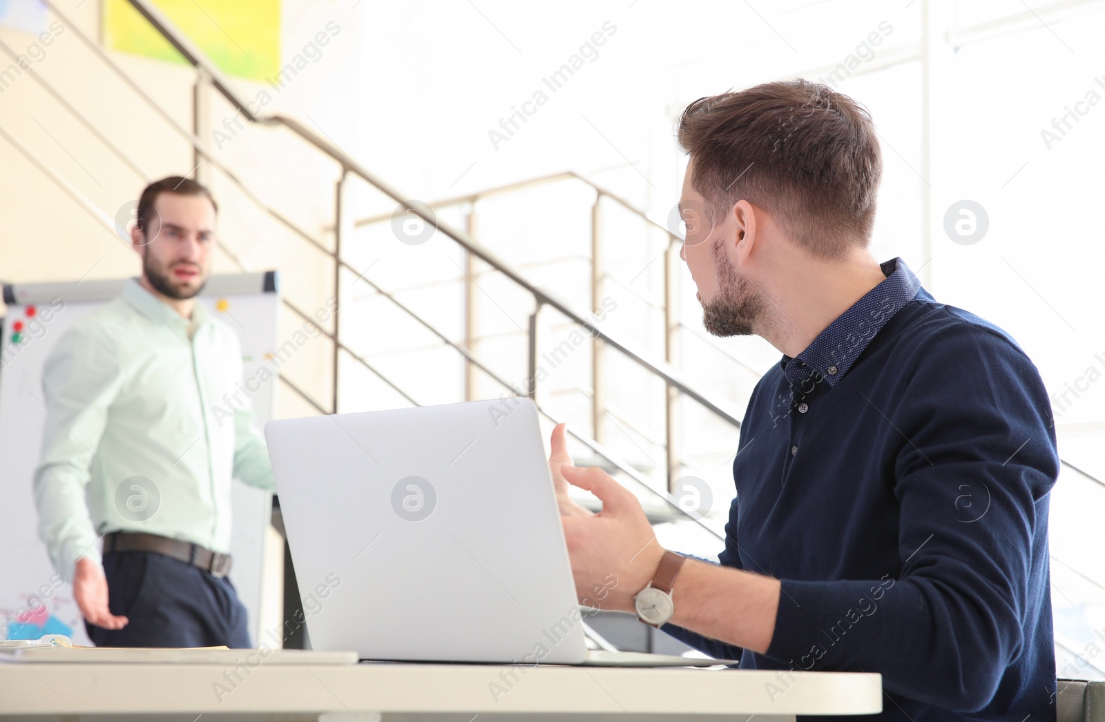 Photo of Office employees having argument at workplace