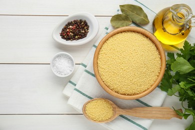 Raw couscous and ingredients on white wooden table, flat lay. Space for text