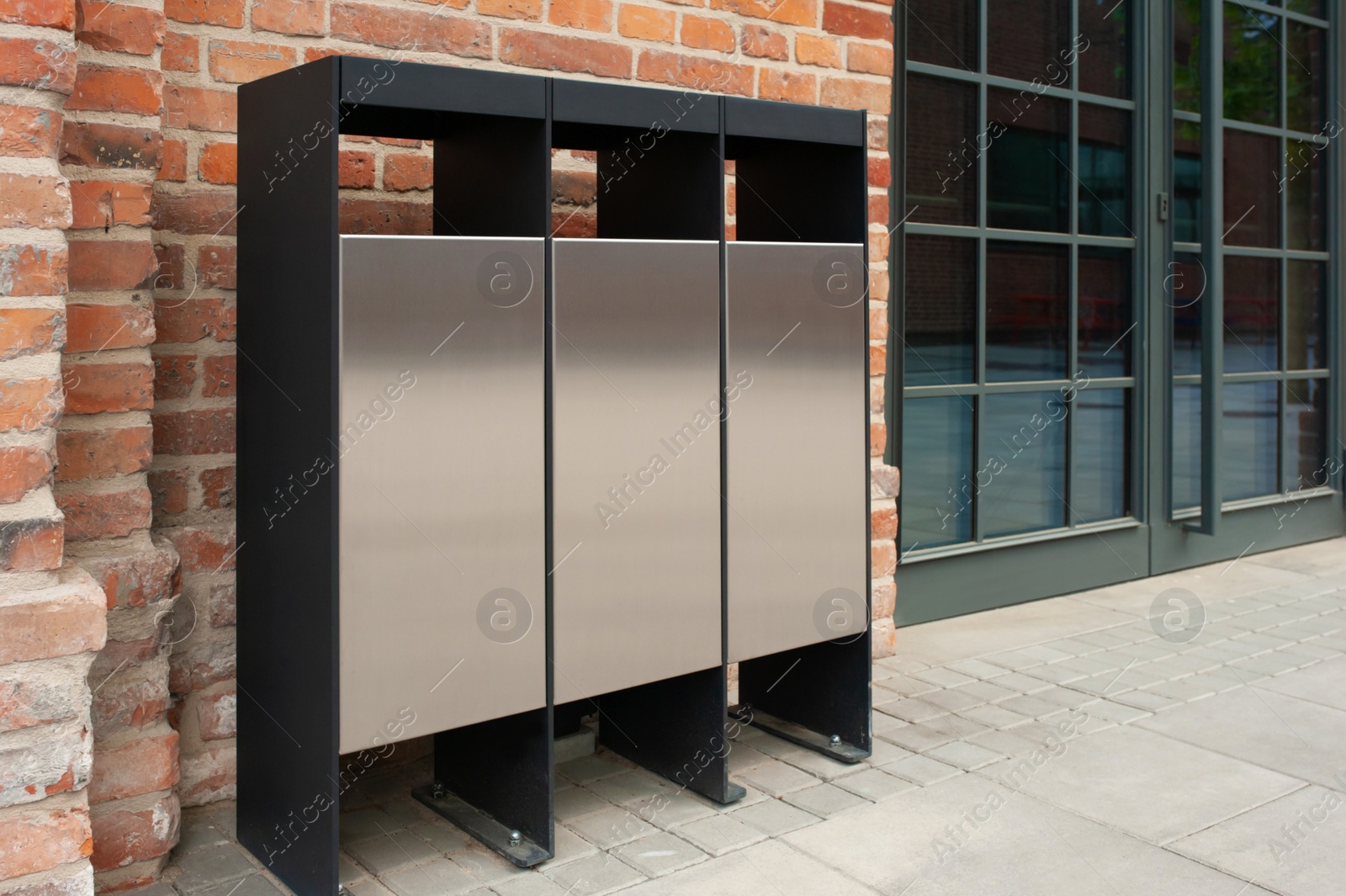 Photo of Recycling bins for waste near building outdoors