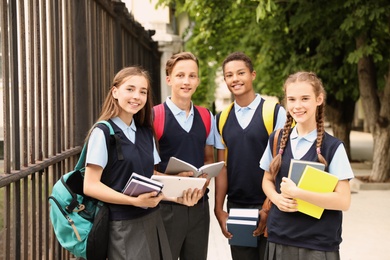 Teenage students in stylish school uniform outdoors