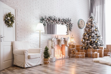 Stylish interior of living room with decorated Christmas tree