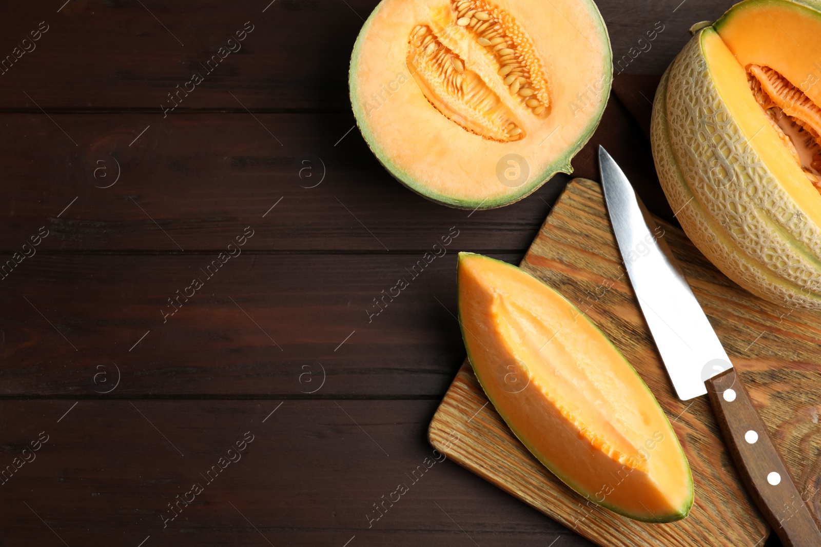 Photo of Tasty fresh melons on wooden table, flat lay. Space for text