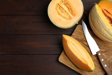 Tasty fresh melons on wooden table, flat lay. Space for text