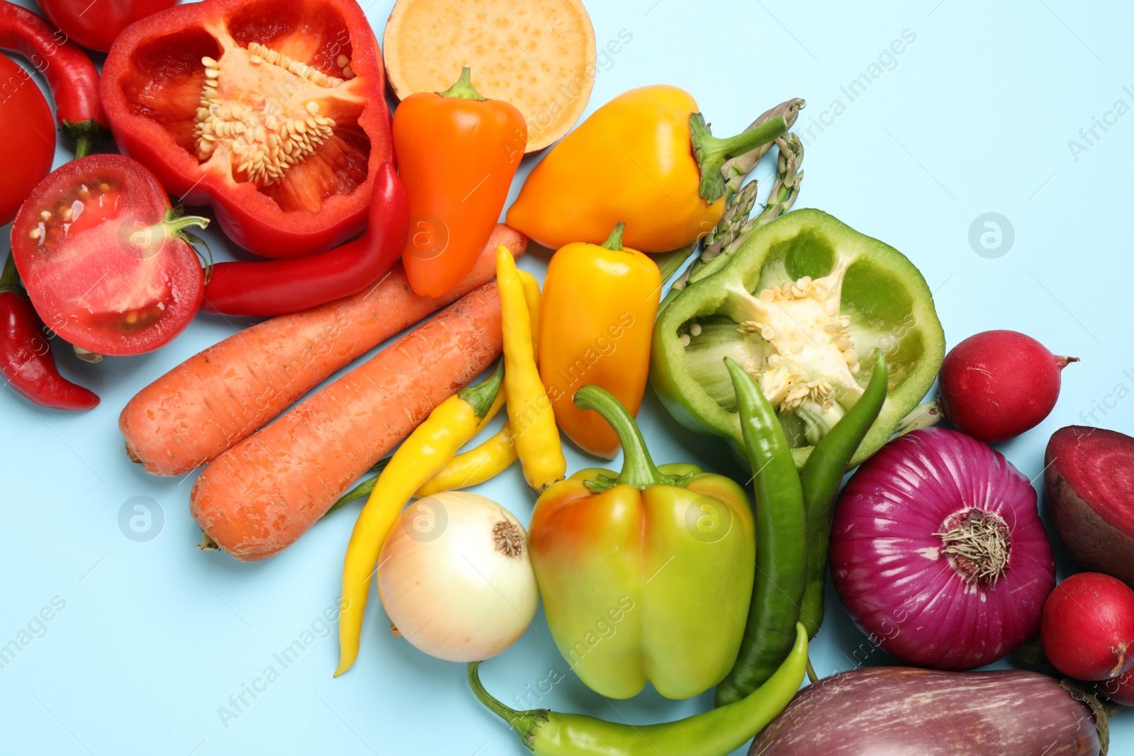 Photo of Flat lay composition with fresh vegetables on light blue background