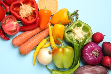 Photo of Flat lay composition with fresh vegetables on light blue background