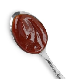 Tasty barbecue sauce in spoon isolated on white, top view