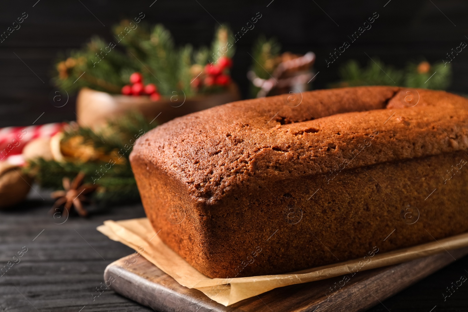 Photo of Delicious gingerbread cake on black wooden table, closeup