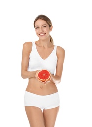 Photo of Happy slim woman in underwear holding grapefruit on white background. Weight loss diet