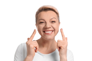 Photo of Mature woman applying face cream on white background