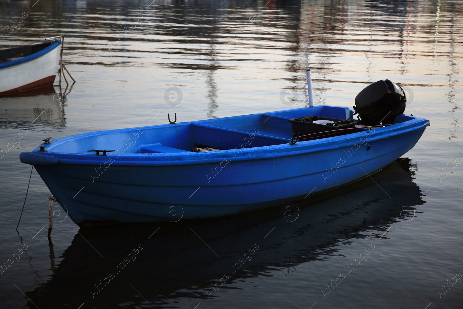 Photo of Beautiful view of river with moored boat at sunset