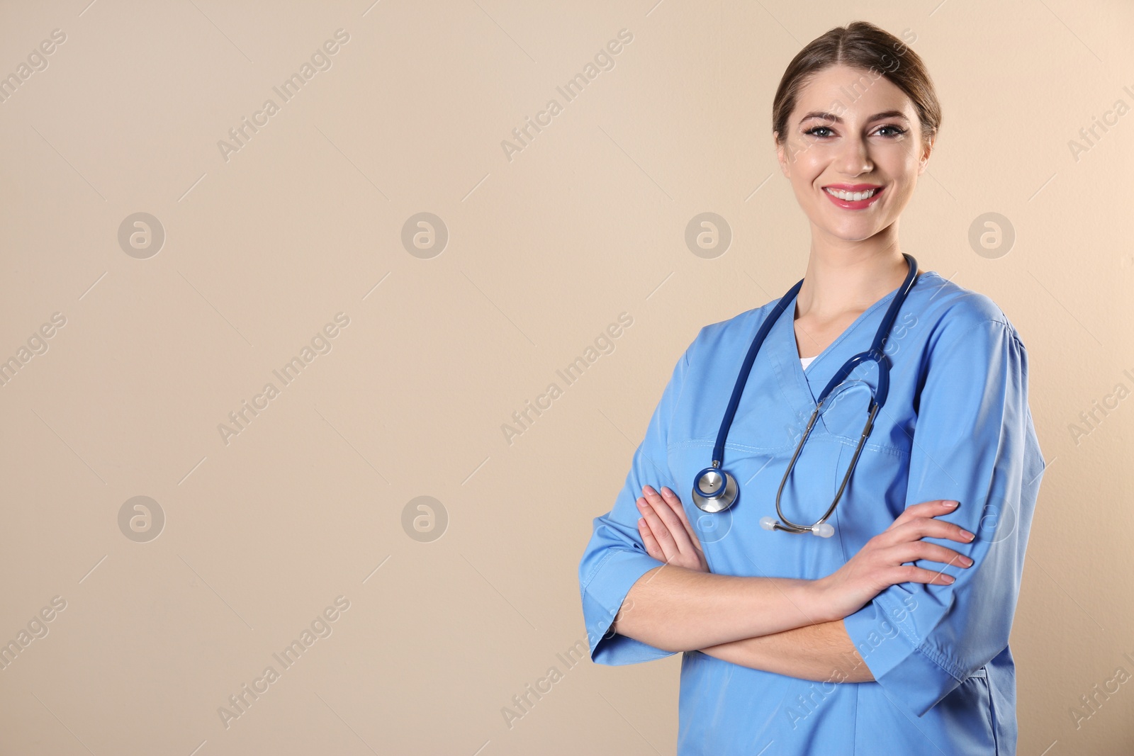 Photo of Young medical student in uniform on color background. Space for text