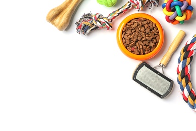 Photo of Bowl with food for dog and accessories on white background. Pet care