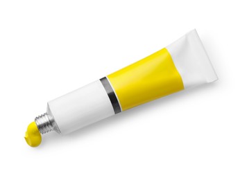 Tube with yellow oil paint on white background, top view