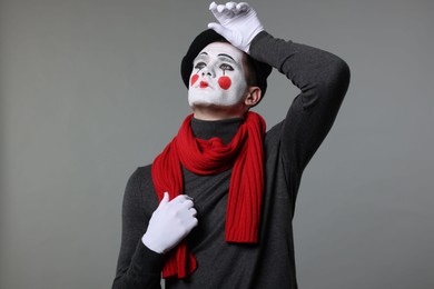 Photo of Portrait of mime artist in beret on grey background