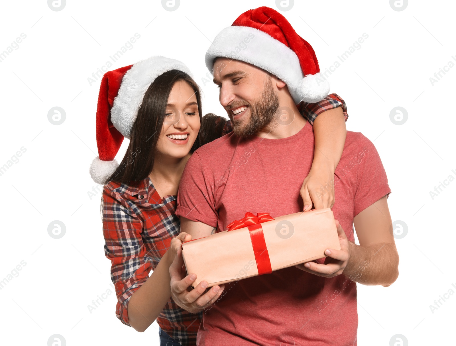 Photo of Young couple with Christmas gift on white background