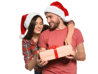 Photo of Young couple with Christmas gift on white background