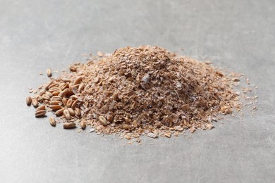 Pile of wheat bran on grey table