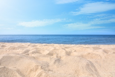 Sandy beach near sea on sunny day