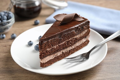 Photo of Delicious fresh chocolate cake served on wooden table