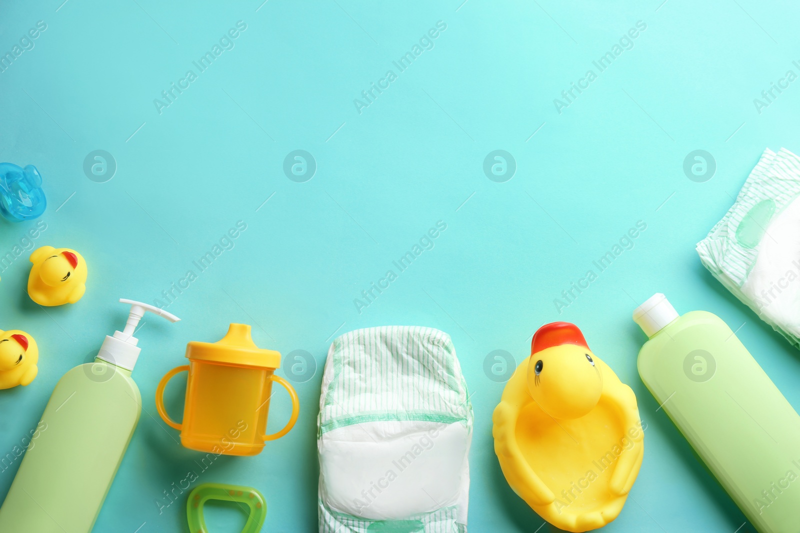 Photo of Flat lay composition with baby accessories and space for text on color background