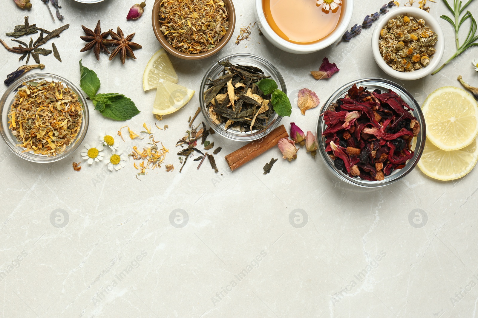 Photo of Flat lay composition with fresh brewed tea and dry leaves on light table, space for text