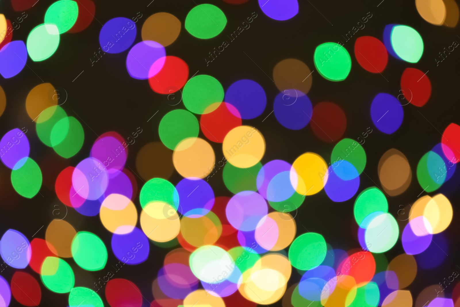 Photo of Beautiful colorful lights on dark background. Bokeh effect