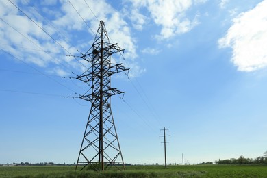 Photo of Field with telephone poles under blue sky