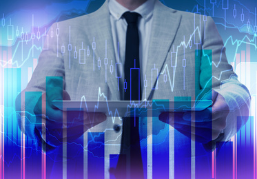 Forex trading. Double exposure of charts and man using tablet computer, closeup
