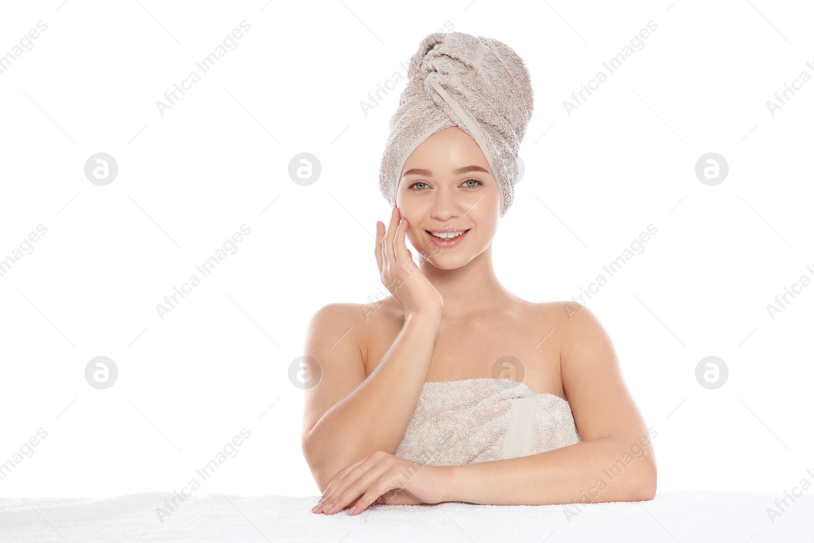 Photo of Portrait of young pretty woman with towels on white background