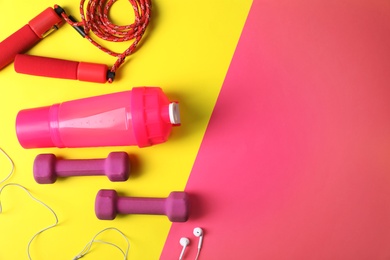 Photo of Flat lay composition with fitness gym equipment on color background. Space for text