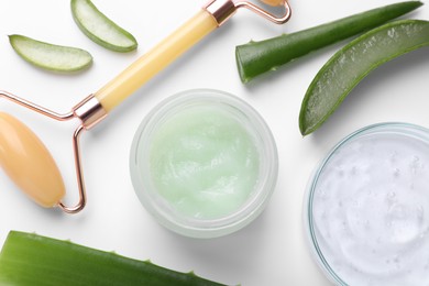 Photo of Flat lay composition with cosmetic products and cut aloe leaves on white background