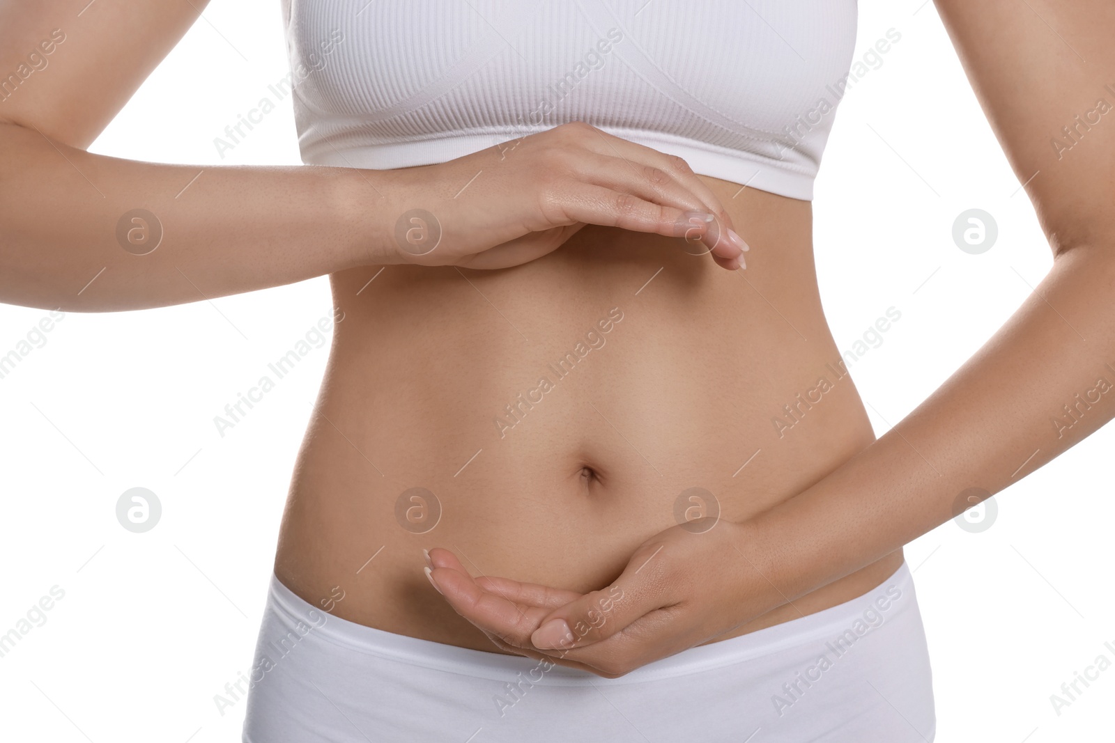 Photo of Woman in underwear holding something near her belly on white background, closeup. Healthy stomach